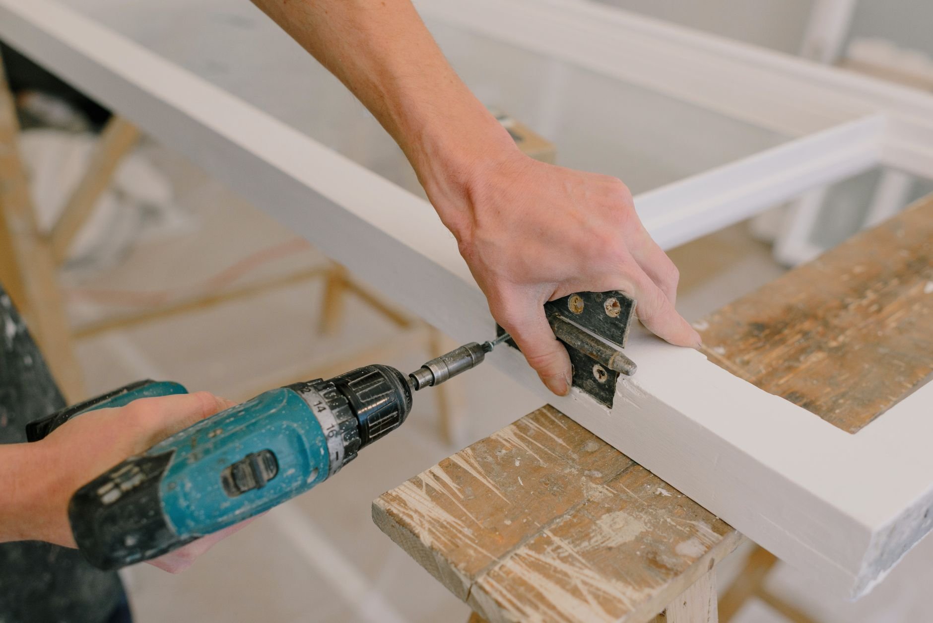Professional tradesperson installing fittings during a home repair job.